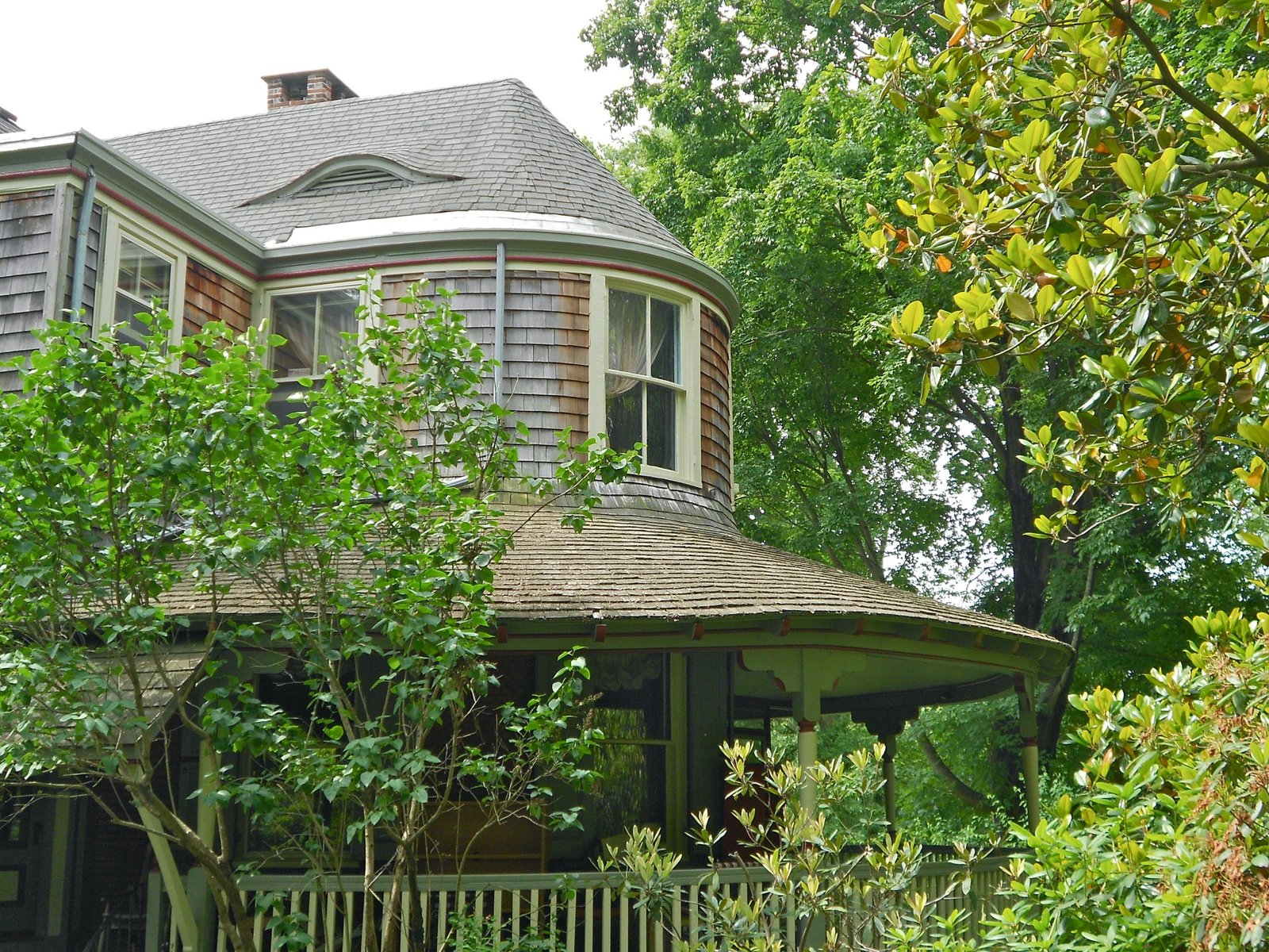 Colonial house set behind a mature garden