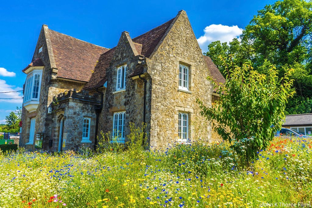 Stone house set behind a mature garden
